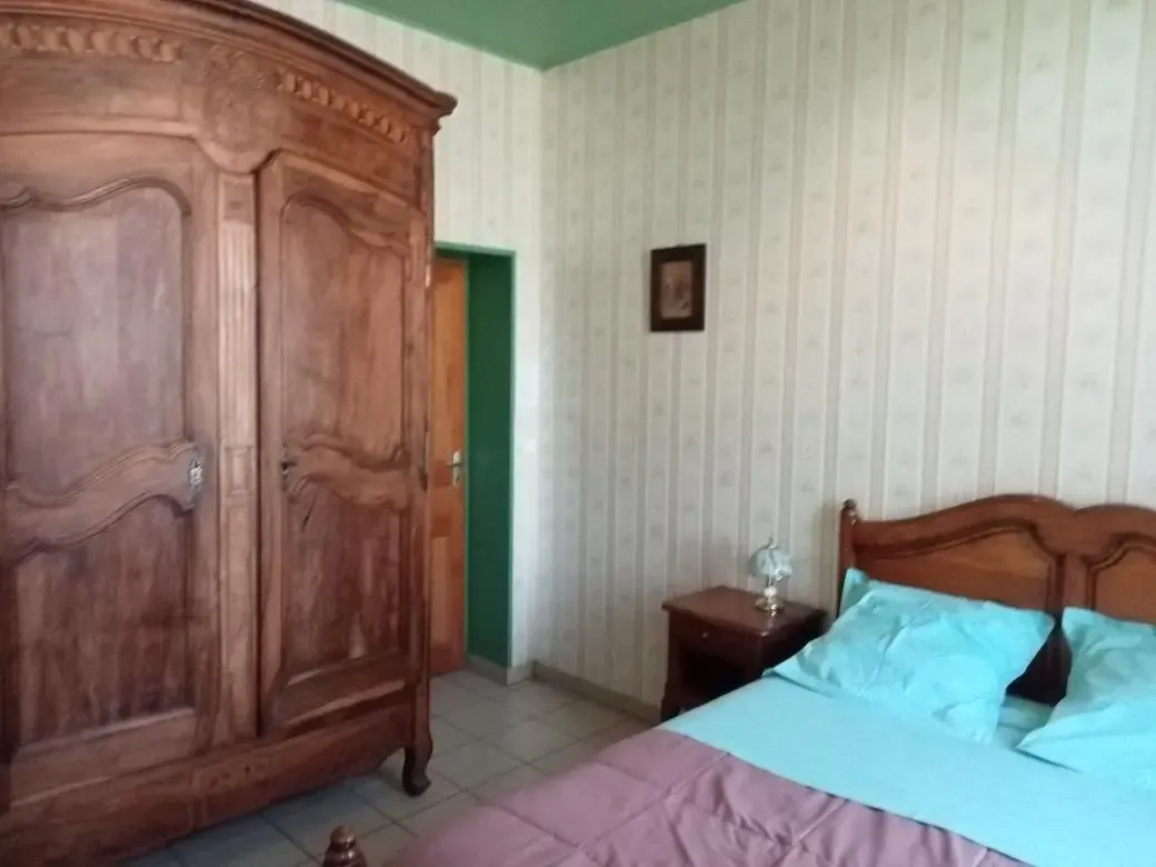 Chambre d’hôtes La Mésange, lit double et armoire ancienne